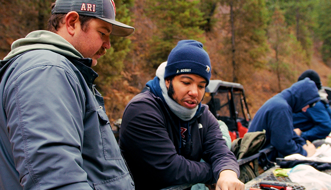 Scout team members outside discussing