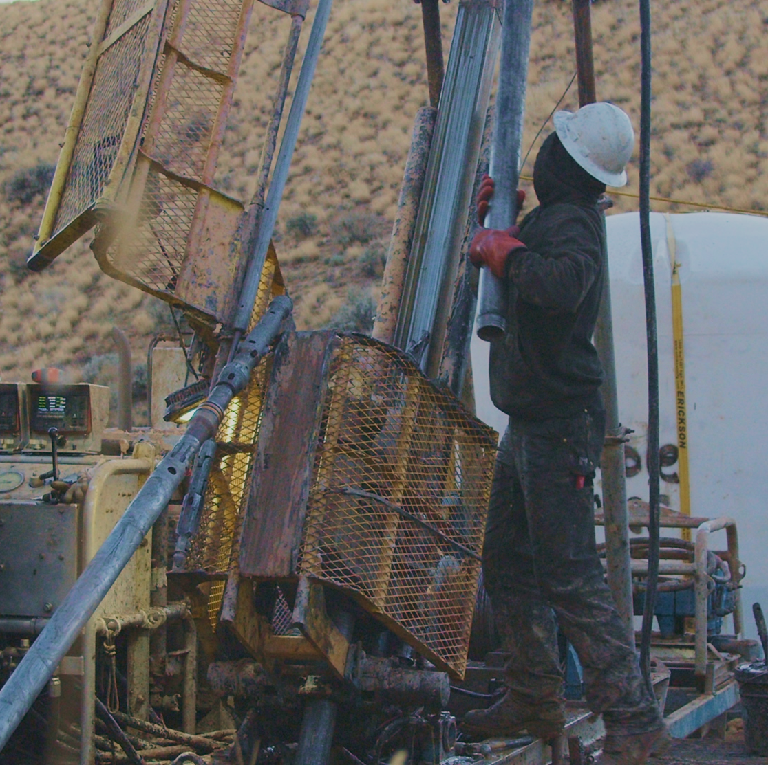 A photograph of a person working on a drill