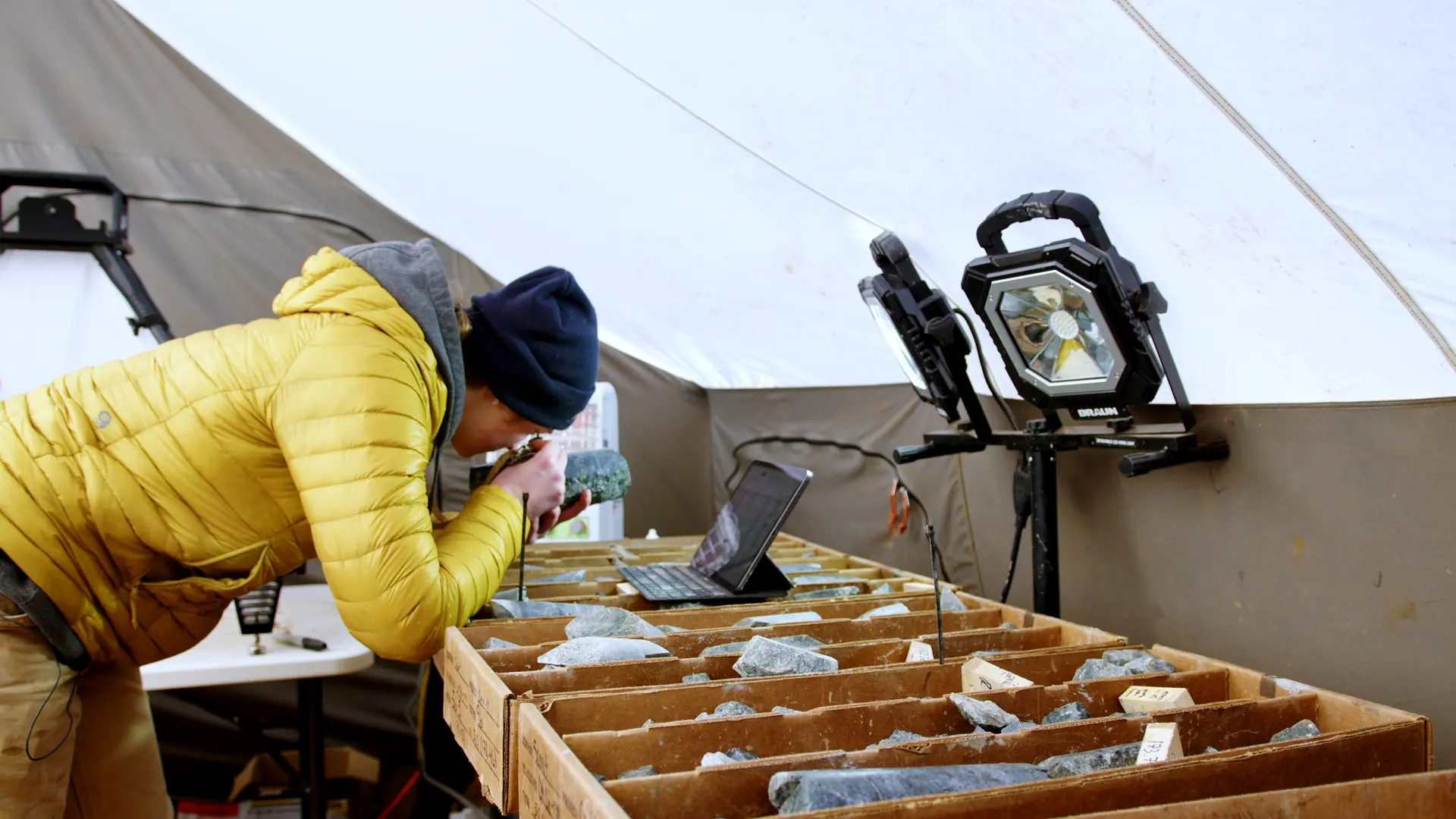 A person inspecting minerals